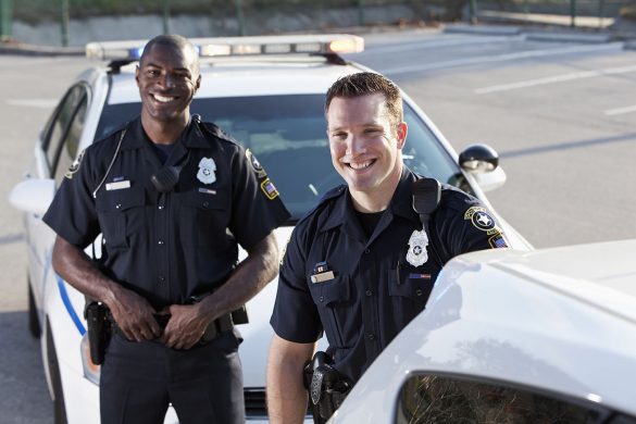 Decorative photo of two male police officers smiling outside