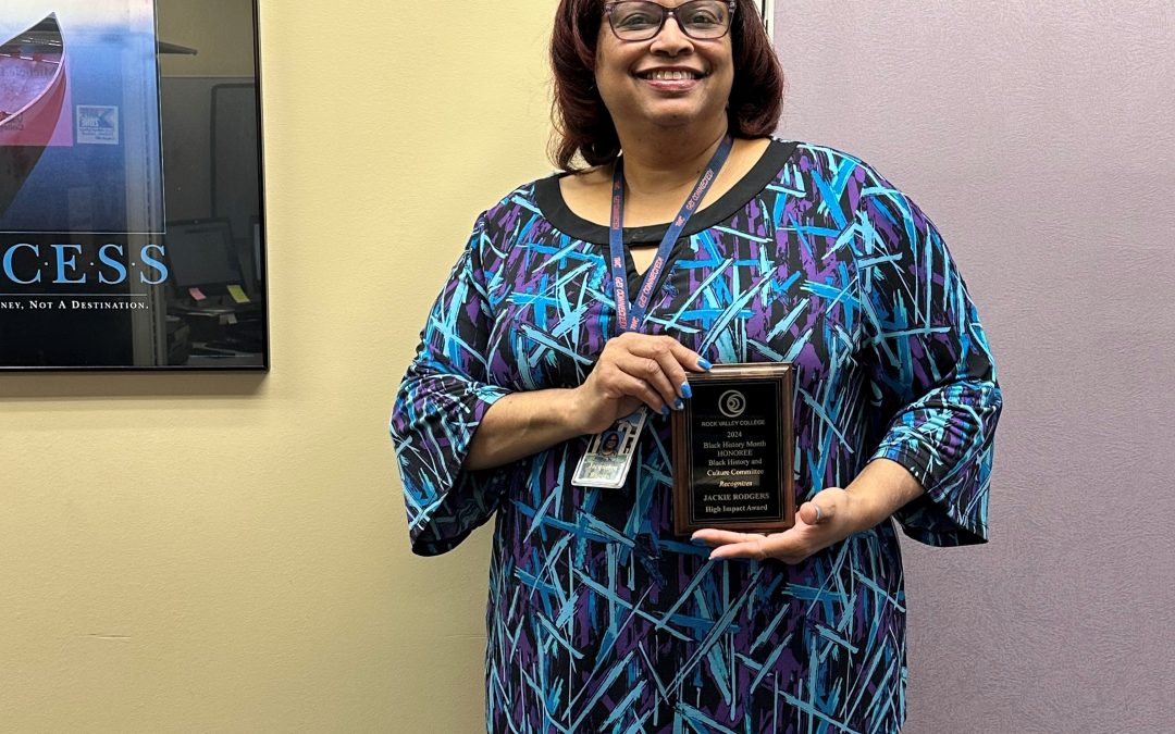 Smiling woman in a patterned shirt holding an award. Story is about The Workforce Connection's Career Planner, Jackie, who was honored at Rock Valley College's Ebony Breakfast with the High Impact Award.